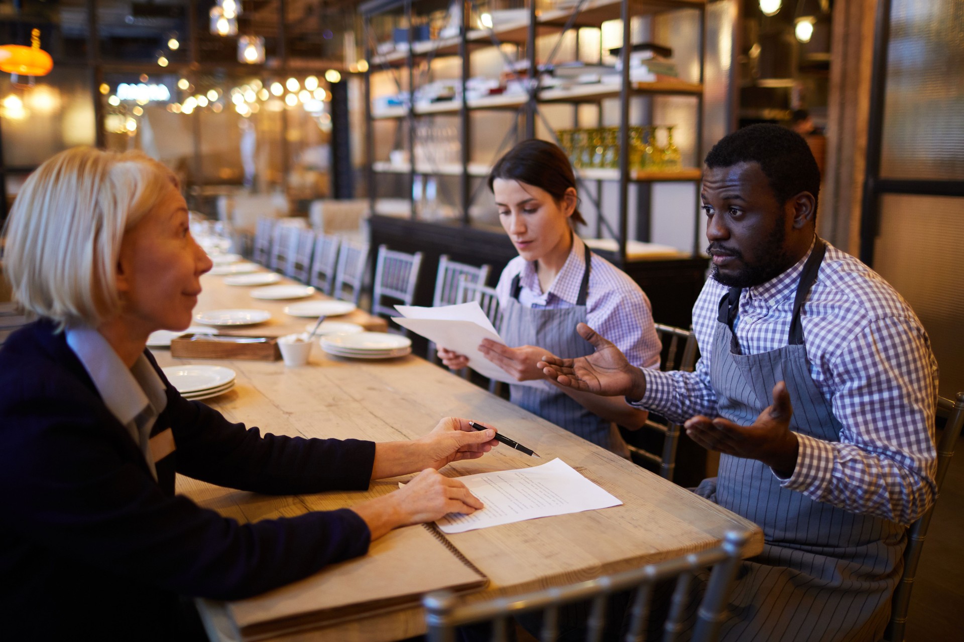 Servers Reading Contract in Restaurant